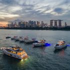 Princess Yachts Rendezvous- Princess Yachts rendezvous against the backdrop of Singapore’s Central Business District skyline at sunset