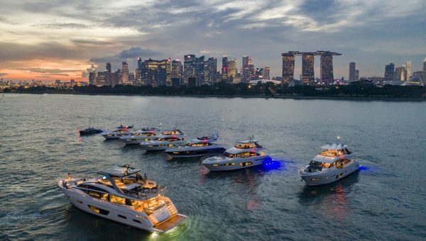 Princess Yachts Rendezvous- Princess Yachts rendezvous against the backdrop of Singapore’s Central Business District skyline at sunset